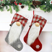 ELITE CASA Christmas stockings hanging on a fireplace, featuring a gnome design and festive colors.