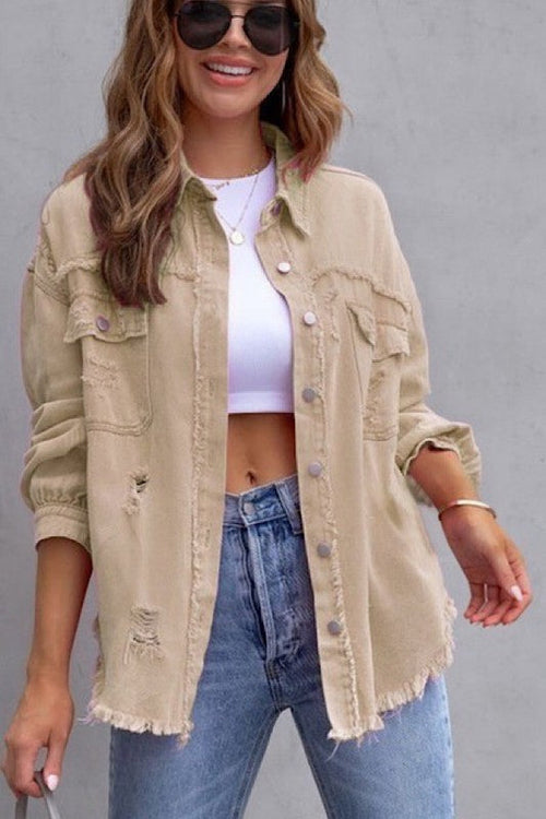 Woman wearing ELITE CASA Tattered Jacket with ripped detail and casual style, paired with jeans and a white top.
