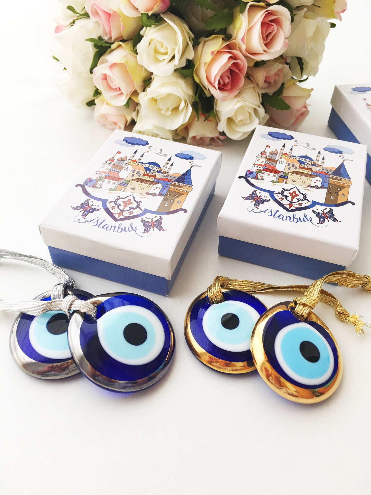 ELITE CASA Christmas gift ideas featuring blue evil eye charm in decorative boxes.