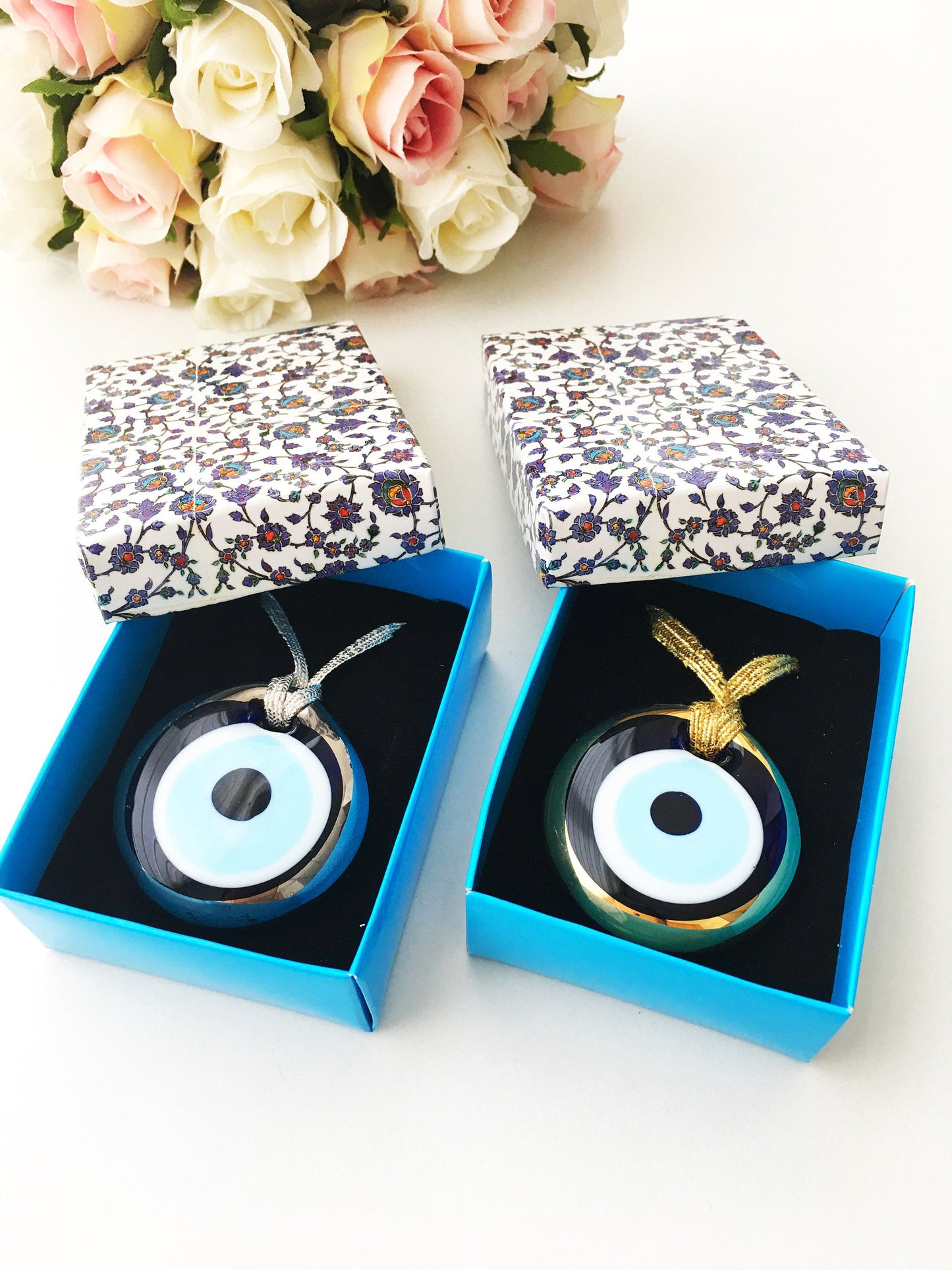 ELITE CASA Christmas gift ideas featuring blue evil eye charm in decorative boxes.