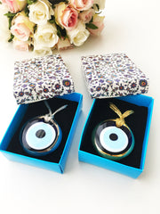 ELITE CASA Christmas gift ideas featuring blue evil eye charm in decorative boxes.
