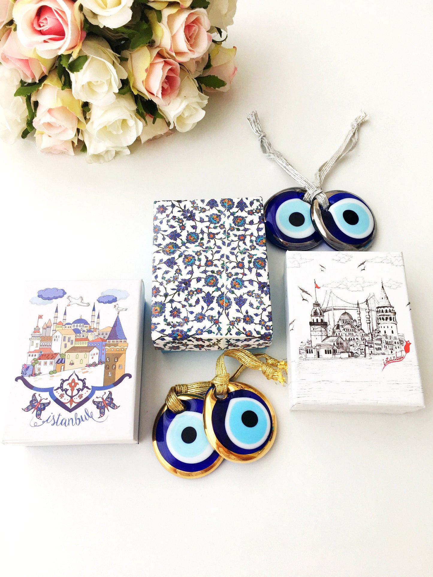 ELITE CASA Christmas gift ideas featuring blue evil eye charm in decorative boxes.