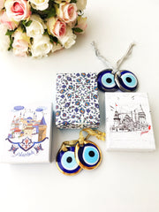 ELITE CASA Christmas gift ideas featuring blue evil eye charm in decorative boxes.
